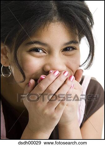 Portrait of a girl covering her mouth with her hands View Large Photo Image Stock Photo - Portrait of a girl covering her mouth with her hands. Fotosearch