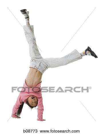 Stock Image - Portrait of a girl doing a hand stand. Fotosearch