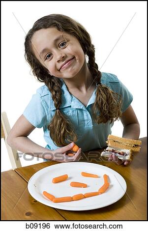 Portrait of a girl eating a sandwich View Large Photo Image Stock Photograph - Portrait of a girl eating a sandwich. Fotosearch