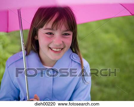Stock Image - Portrait of a girl holding an umbrella. Fotosearch