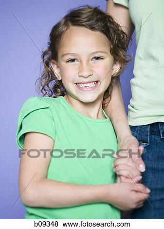 Portrait of a girl holding her mother's hand View Large Photo Image Stock Photo - Portrait of a girl holding her mother's hand. Fotosearch