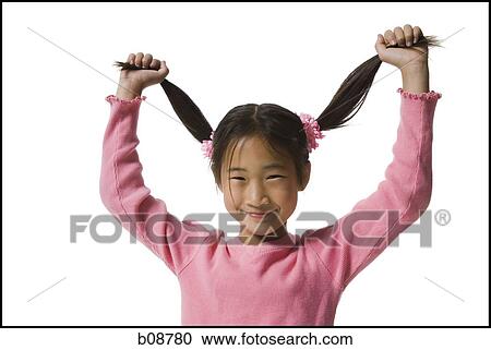 Portrait of a girl holding up her pigtails and smiling View Large Photo Image Stock Image - Portrait of a girl holding up her pigtails and smiling. Fotosearch
