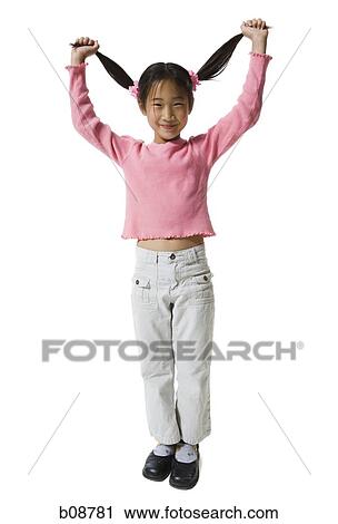 Portrait of a girl holding up her pigtails and smiling View Large Photo Image Stock Image - Portrait of a girl holding up her pigtails and smiling. Fotosearch