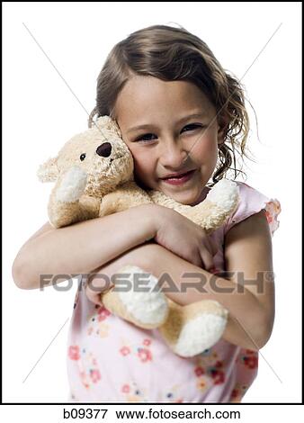 Portrait of a girl hugging a teddy bear View Large Photo Image Stock Photo - Portrait of a girl hugging a teddy bear. Fotosearch