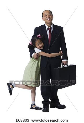 Portrait of a girl hugging her father View Large Photo Image Stock Image - Portrait of a girl hugging her father. Fotosearch
