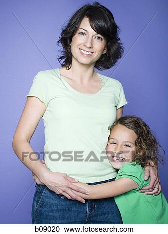 Portrait of a girl hugging her mother View Large Photo Image Stock Image - Portrait of a girl hugging her mother. Fotosearch