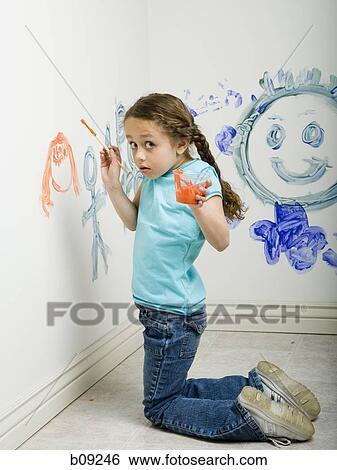 Portrait of a girl painting on a wall View Large Photo Image Stock Photograph - Portrait of a girl painting on a wall. Fotosearch