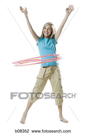 Portrait of a girl playing with a hula hoop View Large Photo Image Stock Image - Portrait of a girl playing with a hula hoop. Fotosearch
