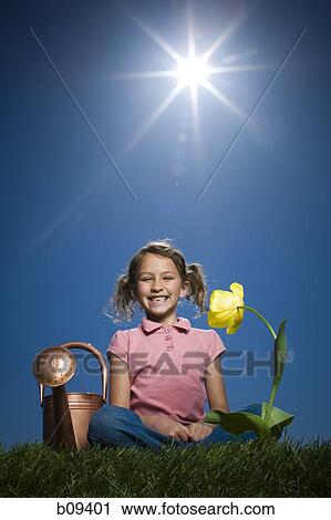 Portrait of a girl sitting beside a watering can View Large Photo Image Stock Image - Portrait of a girl sitting beside a watering can. Fotosearch