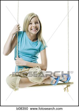 Portrait of a girl sitting on a rope swing View Large Photo Image Stock Image - Portrait of a girl sitting on a rope swing. Fotosearch