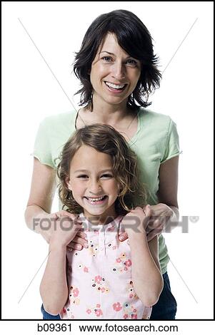 Portrait of a girl standing with her mother View Large Photo Image Stock Image - Portrait of a girl standing with her mother. Fotosearch