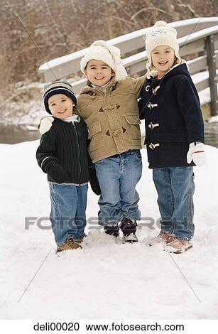 Portrait of a girl standing with her two brothers View Large Photo Image Stock Image - Portrait of a girl standing with her two brothers. Fotosearch