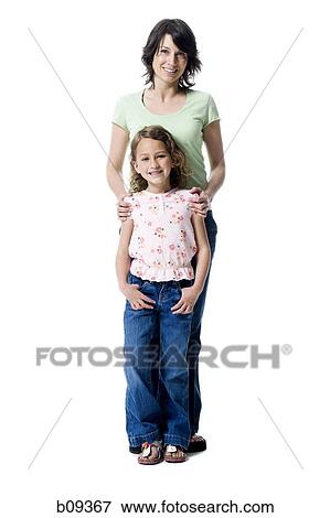 Portrait of a girl standing with her mother View Large Photo Image Stock Photo - Portrait of a girl standing with her mother. Fotosearch