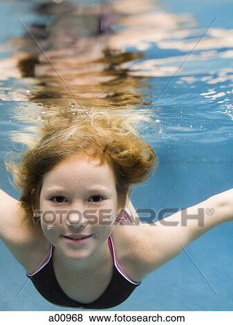 Portrait of a girl swimming underwater View Large Photo Image Stock Photo - Portrait of a girl swimming underwater. Fotosearch