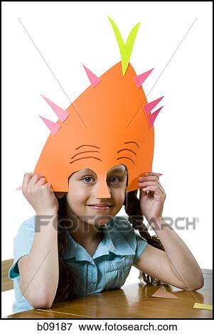 Portrait of a girl wearing a paper mask View Large Photo Image Stock Photo - Portrait of a girl wearing a paper mask. Fotosearch