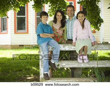Portrait of a man and a woman smiling with their children View Large Photo Image Stock Photo - Portrait of a man and a woman smiling with their children. Fotosearch