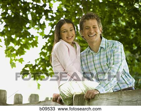 Portrait of a man and his daughter smiling View Large Photo Image Stock Image - Portrait of a man and his daughter smiling. Fotosearch