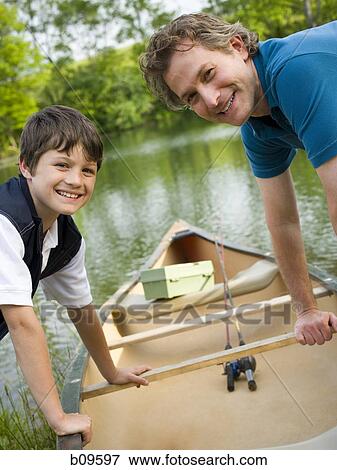 Portrait of a man and his son bending forward over a canoe View Large Photo Image Stock Photo - Portrait of a man and his son bending forward over a canoe. Fotosearch