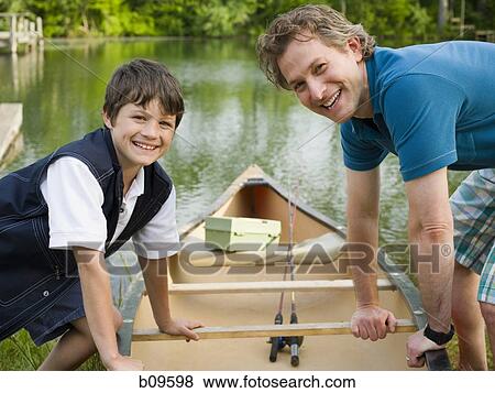 Portrait of a man and his son bending forward over a canoe View Large Photo Image Stock Photo - Portrait of a man and his son bending forward over a canoe. Fotosearch