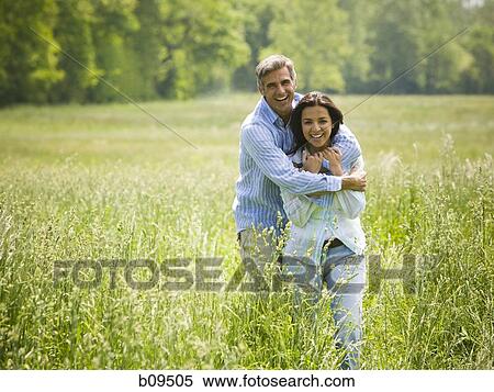 Portrait of a man embracing a woman from behind View Large Photo Image Stock Photography - Portrait of a man embracing a woman from behind. Fotosearch