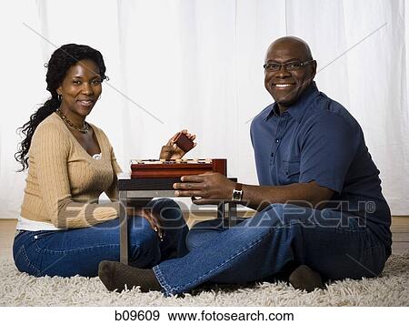 Portrait of a mature couple playing a board game View Large Photo Image Stock Photo - Portrait of a mature couple playing a board game. Fotosearch