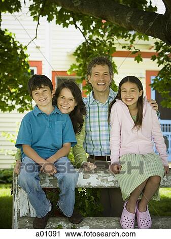 Stock Image - Portrait of a mature man and a mid adult woman with their son and daughter. Fotosearch