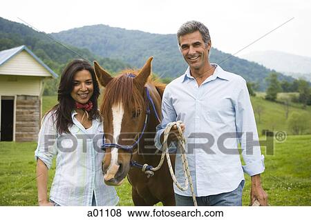 Portrait of a mature man and a woman with a horse View Large Photo Image Stock Photo - Portrait of a mature man and a woman with a horse. Fotosearch