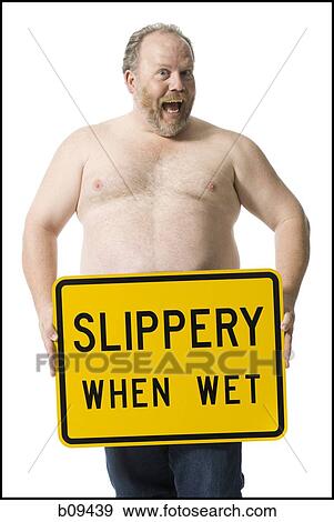 Stock Photo - Portrait of a mature man holding a sign board. Fotosearch