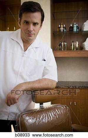 Portrait of a mid adult man leaning against a chair View Large Photo Image Stock Image - Portrait of a mid adult man leaning against a chair. Fotosearch