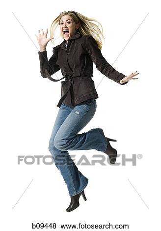 Stock Photo - Portrait of a mid adult woman jumping. Fotosearch