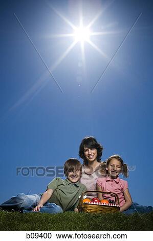 Portrait of a mid adult woman sitting with her son and daughter View Large Photo Image Stock Image - Portrait of a mid adult woman sitting with her son and daughter. Fotosearch