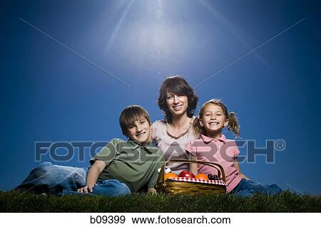 Portrait of a mid adult woman sitting with her son and daughter View Large Photo Image Stock Photo - Portrait of a mid adult woman sitting with her son and daughter. Fotosearch