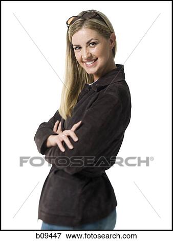 Stock Photo - Portrait of a mid adult woman smiling with her arms crossed. Fotosearch
