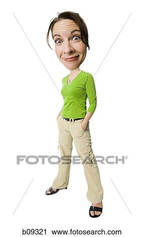 Stock Image - Portrait of a mid adult woman standing with her hands in her pockets. Fotosearch