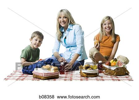 Portrait of a mother and her two children having a picnic View Large Photo Image Stock Photo - Portrait of a mother and her two children having a picnic. Fotosearch