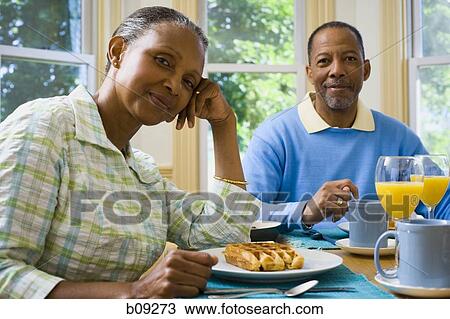 Portrait of a senior man and a senior woman sitting at the breakfast table View Large Photo Image Stock Image - Portrait of a senior man and a senior woman sitting at the breakfast table. Fotosearch