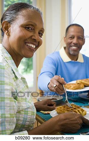 Portrait of a senior man and a senior woman having breakfast View Large Photo Image Stock Image - Portrait of a senior man and a senior woman having breakfast. Fotosearch