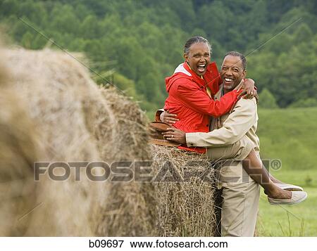 Portrait of a senior man and a senior woman embracing each other View Large Photo Image Stock Photo - Portrait of a senior man and a senior woman embracing each other. Fotosearch
