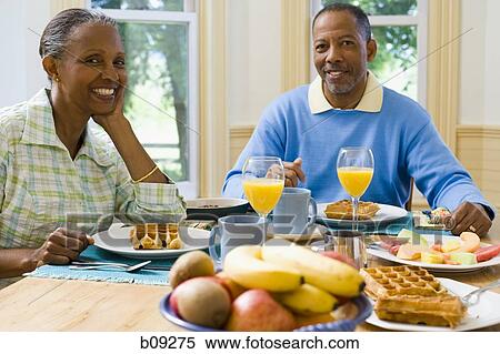 Portrait of a senior man and a senior woman sitting at the breakfast table View Large Photo Image Stock Photography - Portrait of a senior man and a senior woman sitting at the breakfast table. Fotosearch