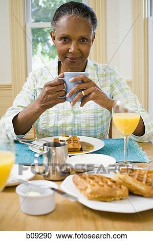 Portrait of a senior woman having breakfast View Large Photo Image Stock Image - Portrait of a senior woman having breakfast. Fotosearch