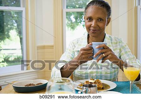 Portrait of a senior woman having breakfast View Large Photo Image Stock Image - Portrait of a senior woman having breakfast. Fotosearch