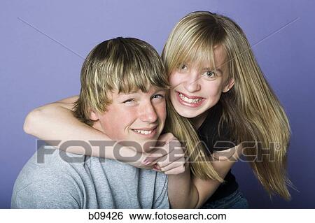 Portrait of a teenage boy and a teenage girl smiling View Large Photo Image Stock Photograph - Portrait of a teenage boy and a teenage girl smiling. Fotosearch