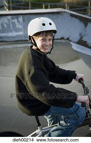 Picture - Portrait of a teenage boy cycling. Fotosearch