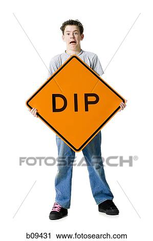 Portrait of a teenage boy holding a sign board View Large Photo Image Stock Image - Portrait of a teenage boy holding a sign board. Fotosearch