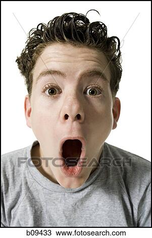 Stock Image - Portrait of a teenage boy with his mouth open. Fotosearch
