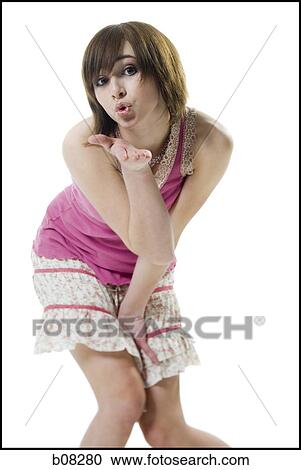 Stock Image - Portrait of a teenage girl blowing a kiss. Fotosearch