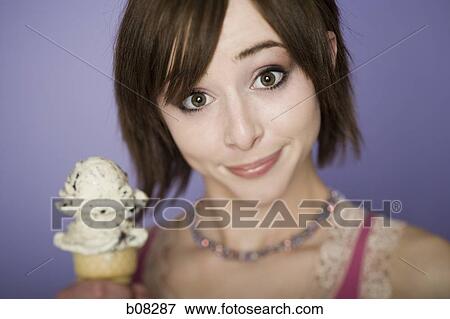 Portrait of a teenage girl holding an ice-cream cone View Large Photo Image Stock Photo - Portrait of a teenage girl holding an ice-cream cone. Fotosearch