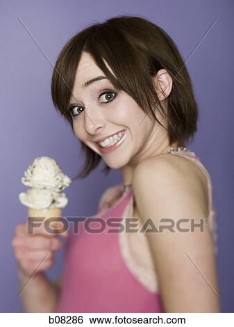 Portrait of a teenage girl holding an ice-cream cone View Large Photo Image Stock Photograph - Portrait of a teenage girl holding an ice-cream cone. Fotosearch