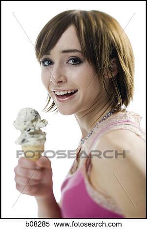 Stock Photography - Portrait of a teenage girl holding an ice-cream cone. Fotosearch