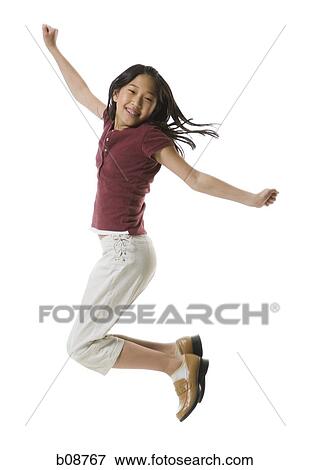 Portrait of a teenage girl jumping with her arms outstretched View Large Photo Image Stock Photo - Portrait of a teenage girl jumping with her arms outstretched. Fotosearch